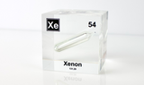 Clear acrylic cube displaying a Xenon element (Atomic Number 54) embedded within, offering a scientific presentation for collectors and science enthusiasts.