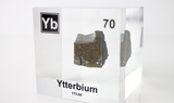Clear acrylic cube displaying an Ytterbium element (Atomic Number 70) embedded within, offering a scientific presentation for collectors and science enthusiasts.