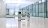 Clear acrylic cube displaying an Ytterbium element (Atomic Number 70) embedded within, offering a scientific presentation for collectors and science enthusiasts.