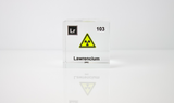 Clear acrylic cube displaying a Lawrencium element (Atomic Number 103) embedded within, offering a scientific presentation for collectors and science enthusiasts.