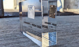Clear acrylic display case featuring a historical fragment of a Chernobyl medic box, offering an educational presentation for collectors and those interested in nuclear history.