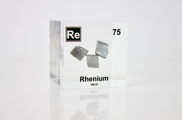Rhenium element in a clear acrylic cube, featuring its name, atomic number, and properties as shown on the periodic table. A sleek and educational display for collectors and enthusiasts.