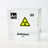 Clear acrylic cube displaying an Actinium element (Atomic Number 89) embedded within, offering a scientific presentation for collectors and science enthusiasts.