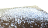 Close-up of Aerogel crystals on a surface with a white background