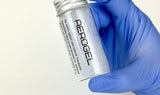 Hand wearing a blue glove holding a silver canister labeled 'Aerogel' on a white background