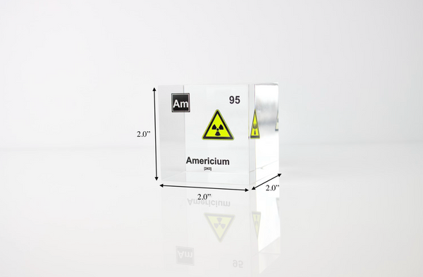 Clear acrylic cube displaying an Americium element (Atomic Number 95) embedded within, offering a scientific presentation for collectors and science enthusiasts. Radiation symbol.