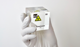 Clear acrylic cube displaying an Americium element (Atomic Number 95) embedded within, offering a scientific presentation for collectors and science enthusiasts. Radiation symbol.