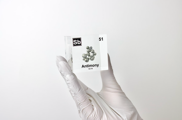 Clear acrylic cube displaying an Antimony element (Atomic Number 51) embedded within, offering a scientific presentation for collectors and science enthusiasts.