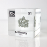 Clear acrylic cube displaying an Antimony element (Atomic Number 51) embedded within, offering a scientific presentation for collectors and science enthusiasts.