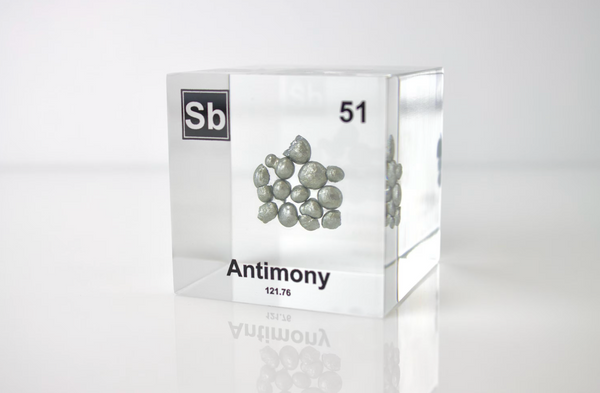 Clear acrylic cube displaying an Antimony element (Atomic Number 51) embedded within, offering a scientific presentation for collectors and science enthusiasts.