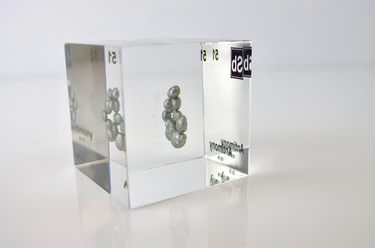 Clear acrylic cube displaying an Antimony element (Atomic Number 51) embedded within, offering a scientific presentation for collectors and science enthusiasts.