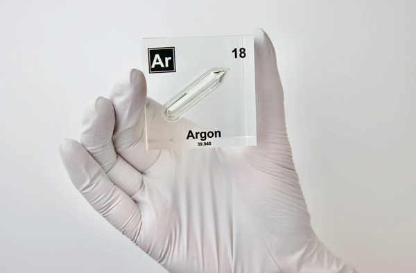 Clear acrylic cube displaying an Argon element (Atomic Number 18) embedded within, offering a scientific presentation for collectors and science enthusiasts.