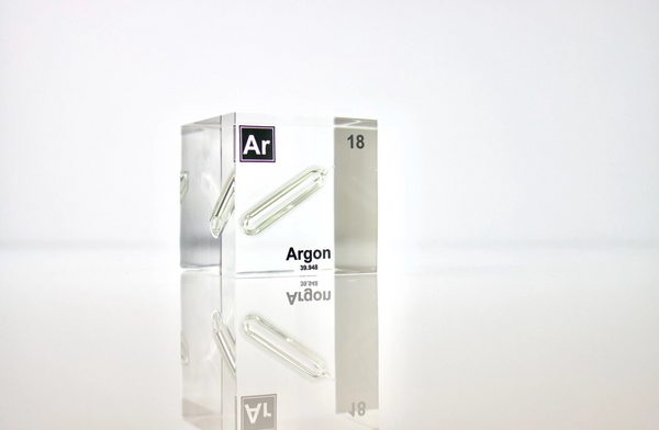 Clear acrylic cube displaying an Argon element (Atomic Number 18) embedded within, offering a scientific presentation for collectors and science enthusiasts.