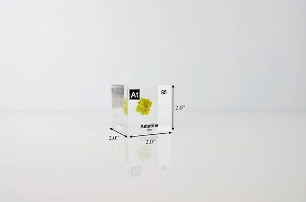 Clear acrylic cube displaying an Astatine element (Atomic Number 85) embedded within, offering a scientific presentation for collectors and science enthusiasts.