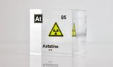 Clear acrylic cube displaying an Astatine element (Atomic Number 85) embedded within, offering a scientific presentation for collectors and science enthusiasts. Radiation symbol.