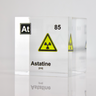 Clear acrylic cube displaying an Astatine element (Atomic Number 85) embedded within, offering a scientific presentation for collectors and science enthusiasts. Radiation symbol.