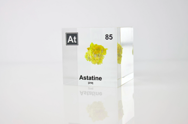 Clear acrylic cube displaying an Astatine element (Atomic Number 85) embedded within, offering a scientific presentation for collectors and science enthusiasts.