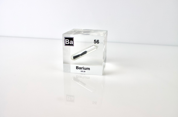 Clear acrylic cube displaying a Barium element (Atomic Number 56) embedded within, offering a scientific presentation for collectors and science enthusiasts.