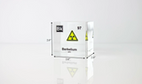Clear acrylic cube displaying a Berkelium element (Atomic Number 97) embedded within, offering a scientific presentation for collectors and science enthusiasts. Radiation symbol.