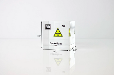 Clear acrylic cube displaying a Berkelium element (Atomic Number 97) embedded within, offering a scientific presentation for collectors and science enthusiasts. Radiation symbol.