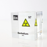 Clear acrylic cube displaying a Berkelium element (Atomic Number 97) embedded within, offering a scientific presentation for collectors and science enthusiasts. Radiation symbol.