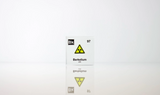 Clear acrylic cube displaying a Berkelium element (Atomic Number 97) embedded within, offering a scientific presentation for collectors and science enthusiasts. Radiation symbol.