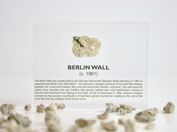 Clear acrylic display case featuring a historical fragment of the Berlin Wall, providing an authentic and educational presentation for history enthusiasts and collectors.