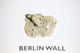 Clear acrylic display case featuring a historical fragment of the Berlin Wall, providing an authentic and educational presentation for history enthusiasts and collectors.