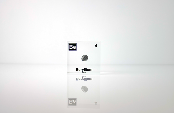 Clear acrylic cube encasing a Beryllium ampule with its atomic number 4. Ideal for display in educational settings, scientific collections, or as a decorative piece.