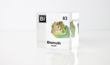 Clear acrylic cube displaying a Bismuth element (Atomic Number 83) embedded within, offering a scientific presentation for collectors and science enthusiasts.