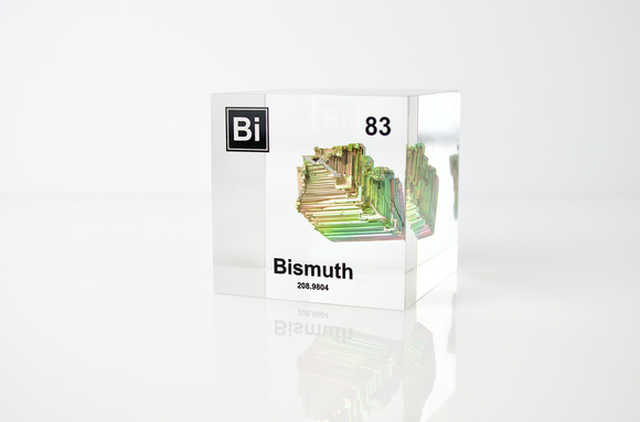 Clear acrylic cube displaying a Bismuth element (Atomic Number 83) embedded within, offering a scientific presentation for collectors and science enthusiasts.