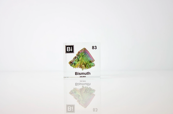 Clear acrylic cube displaying a Bismuth element (Atomic Number 83) embedded within, offering a scientific presentation for collectors and science enthusiasts.