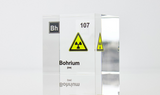Clear acrylic cube displaying a Bohrium element (Atomic Number 107) embedded within, offering a scientific presentation for collectors and science enthusiasts. Radiation symbol.