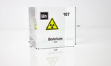 Clear acrylic cube displaying a Bohrium element (Atomic Number 107) embedded within, offering a scientific presentation for collectors and science enthusiasts. Radiation symbol.