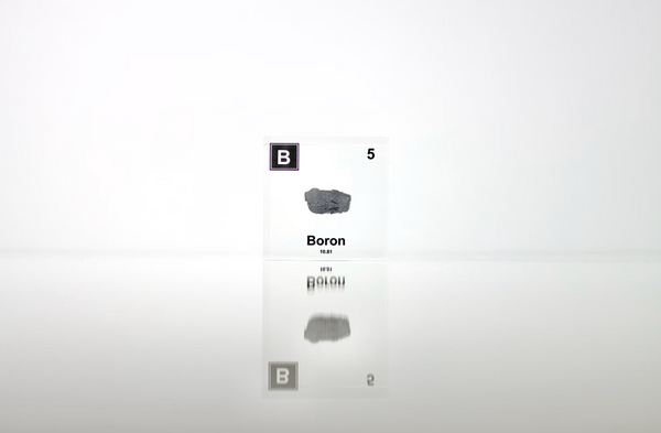 Clear acrylic cube encasing a Boron ampule with its atomic number 5. Ideal for display in educational settings, scientific collections, or as a decorative piece.