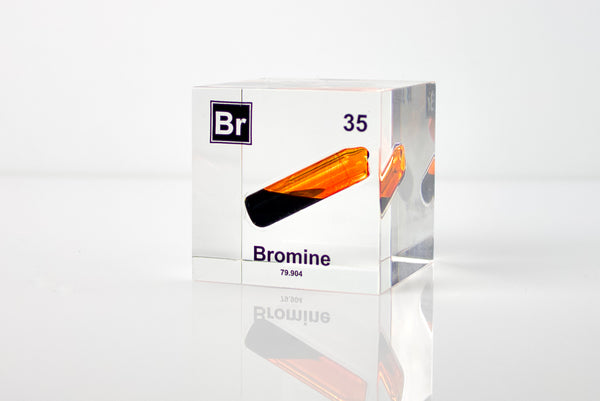 Clear acrylic cube displaying a Bromine element (Atomic Number 35) embedded within, offering a scientific presentation for collectors and science enthusiasts.