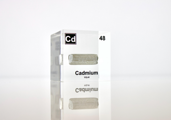 Clear acrylic cube displaying a Cadmium element (Atomic Number 48) embedded within, offering a scientific presentation for collectors and science enthusiasts.