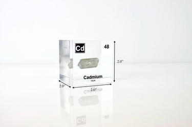 Clear acrylic cube displaying a Cadmium element (Atomic Number 48) embedded within, offering a scientific presentation for collectors and science enthusiasts.