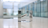 Clear acrylic cube displaying a Calcium element (Atomic Number 20) embedded within, offering a scientific presentation for collectors and science enthusiasts.