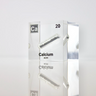 Clear acrylic cube displaying a Calcium element (Atomic Number 20) embedded within, offering a scientific presentation for collectors and science enthusiasts.