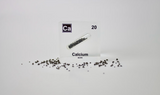 Clear acrylic cube displaying a Calcium element (Atomic Number 20) embedded within, offering a scientific presentation for collectors and science enthusiasts.