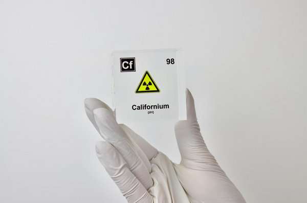 Clear acrylic cube displaying a Californium element (Atomic Number 98) embedded within, offering a scientific presentation for collectors and science enthusiasts.