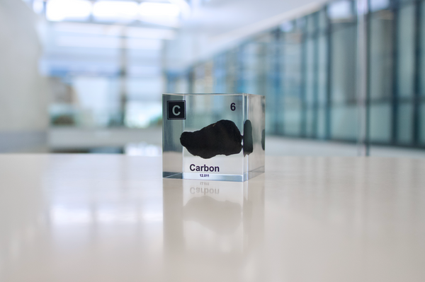 Clear acrylic cube encasing a Carbon ampule with its atomic number 6. Ideal for display in educational settings, scientific collections, or as a decorative piece.