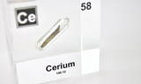Clear acrylic cube displaying a Cerium element (Atomic Number 58) embedded within, offering a scientific presentation for collectors and science enthusiasts.