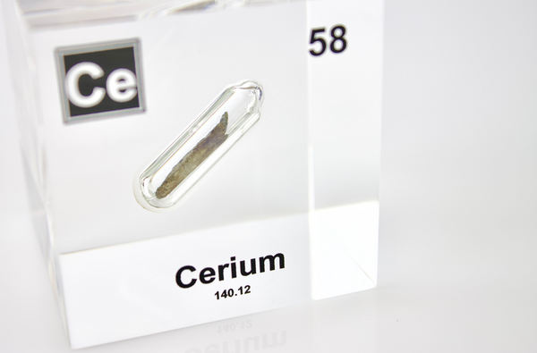 Clear acrylic cube displaying a Cerium element (Atomic Number 58) embedded within, offering a scientific presentation for collectors and science enthusiasts.