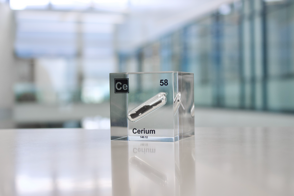 Clear acrylic cube displaying a Cerium element (Atomic Number 58) embedded within, offering a scientific presentation for collectors and science enthusiasts.