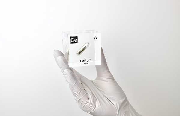 Clear acrylic cube displaying a Cerium element (Atomic Number 58) embedded within, offering a scientific presentation for collectors and science enthusiasts.