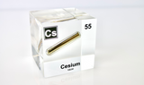 Clear acrylic cube displaying a Cesium element (Atomic Number 55) embedded within, offering a scientific presentation for collectors and science enthusiasts.