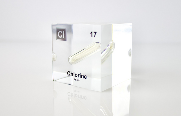 Clear acrylic cube displaying a Chlorine element (Atomic Number 17) embedded within, offering a scientific presentation for collectors and science enthusiasts.