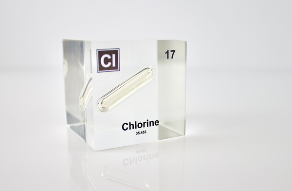 Clear acrylic cube displaying a Chlorine element (Atomic Number 17) embedded within, offering a scientific presentation for collectors and science enthusiasts.